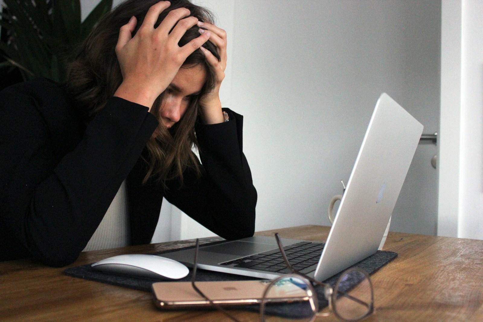 a woman sitting in front of a laptop computer